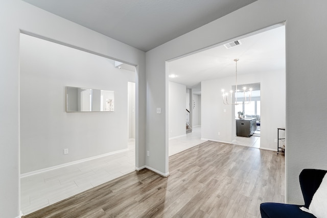 interior space featuring a chandelier and light hardwood / wood-style floors