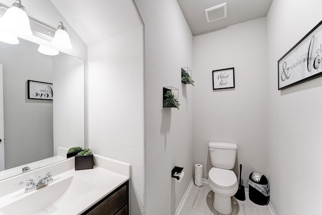 bathroom with toilet and vanity