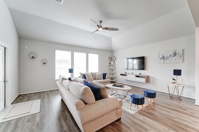 living room featuring lofted ceiling, ceiling fan, and wood-type flooring