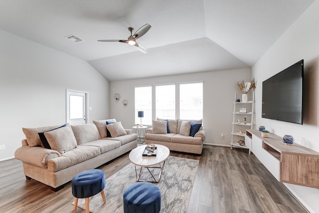 living room featuring lofted ceiling, a healthy amount of sunlight, ceiling fan, and dark hardwood / wood-style flooring