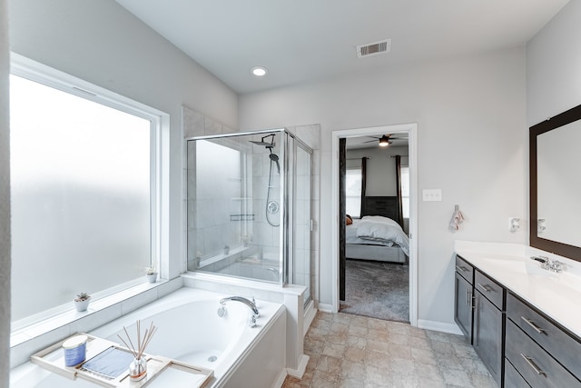 bathroom featuring vanity, independent shower and bath, and ceiling fan