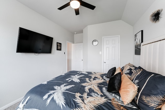 carpeted bedroom featuring ceiling fan and vaulted ceiling