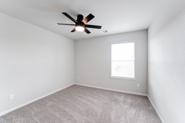 carpeted spare room with ceiling fan