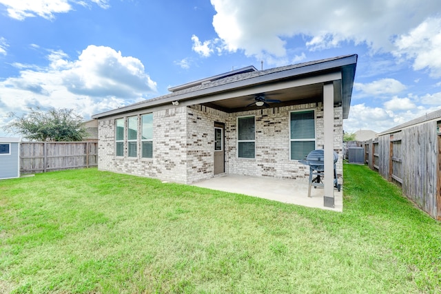 back of property with ceiling fan, a yard, a patio area, and central AC unit