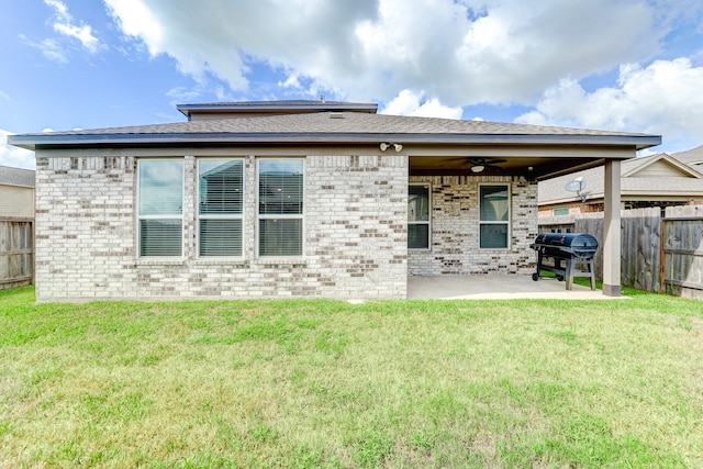 rear view of house with a yard, ceiling fan, and a patio