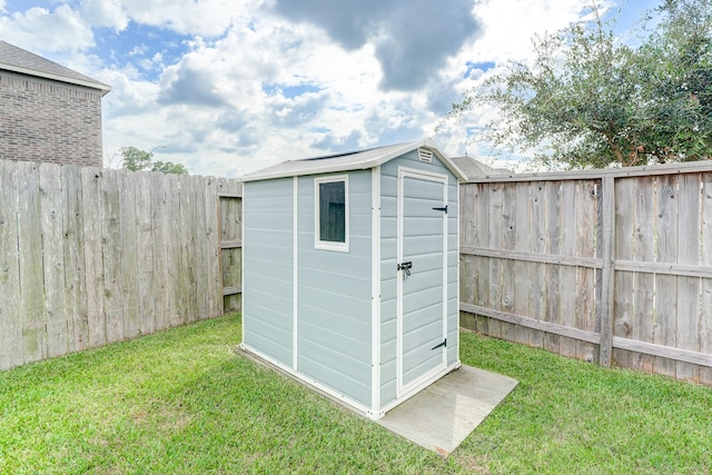 view of outbuilding with a lawn