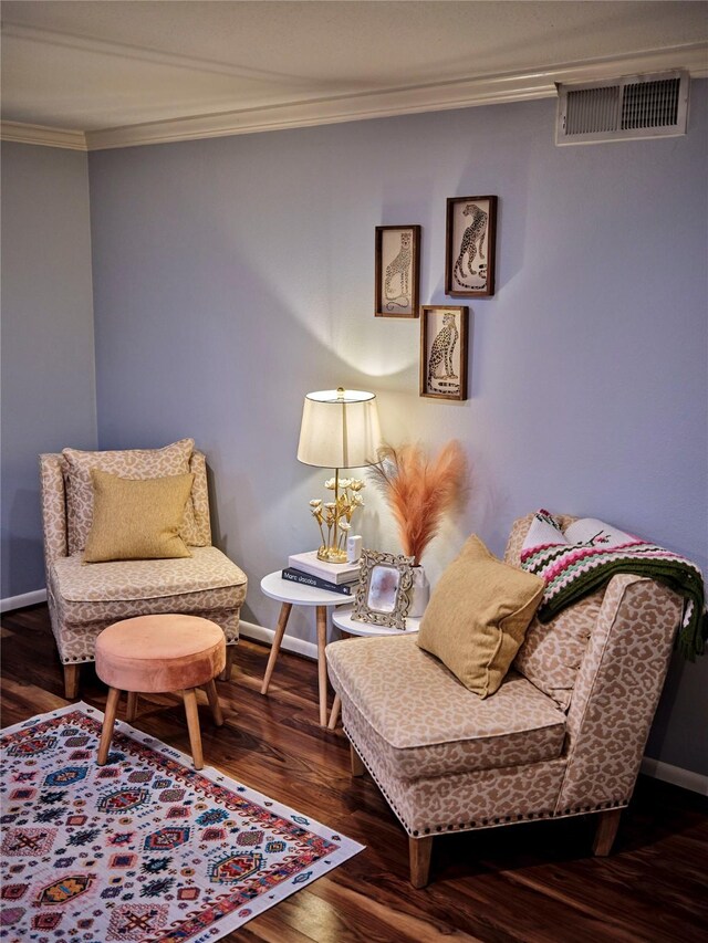 living area with ornamental molding and dark hardwood / wood-style flooring