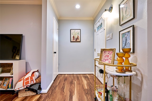 hallway with crown molding and light hardwood / wood-style flooring