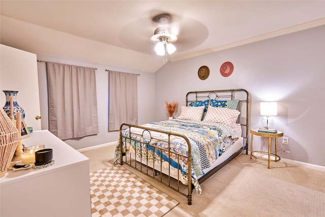 carpeted bedroom with crown molding, vaulted ceiling, and ceiling fan