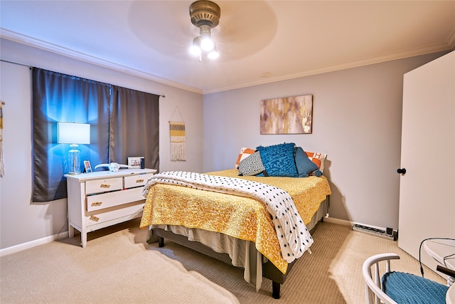 carpeted bedroom with ceiling fan and ornamental molding