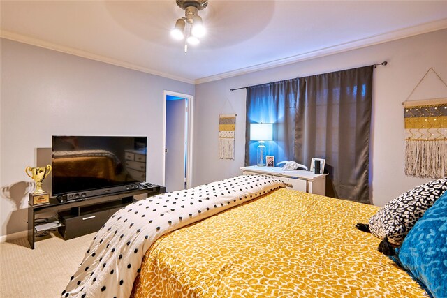 carpeted bedroom featuring ceiling fan and ornamental molding