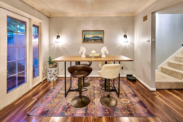 dining space with stairs, ornamental molding, wood finished floors, and baseboards