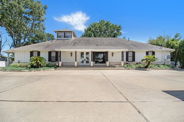 view of front of house with french doors and covered porch