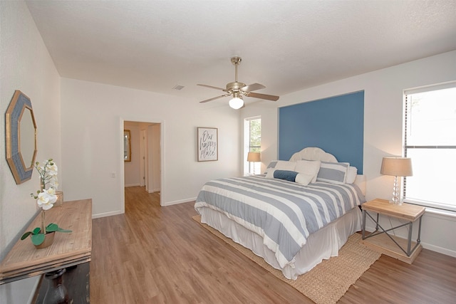 3821 Nasa Rd Unit 1, Seabrook, TX 77586 - bedroom featuring light wood-style flooring and ceiling fan