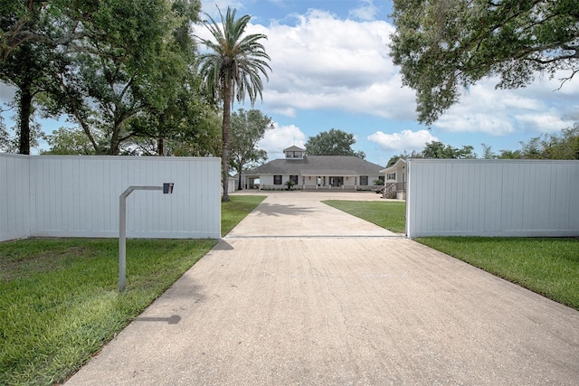 3821 Nasa Rd Unit 1, Seabrook, TX 77586 - view of concrete driveway featuring a gated entry