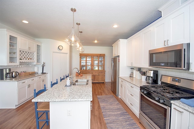 3821 Nasa Rd Unit 1, Seabrook, TX 77586 - kitchen with appliances with stainless steel finishes, white cabinetry, decorative backsplash, recessed lighting, and a textured ceiling