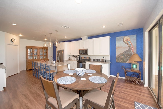 3821 Nasa Rd Unit 1, Seabrook, TX 77586 - dining room featuring wood finished floors and recessed lighting