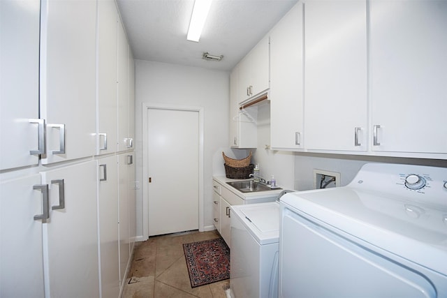 3821 Nasa Rd Unit 1, Seabrook, TX 77586 - laundry area featuring cabinet space, independent washer and dryer, and light tile patterned flooring