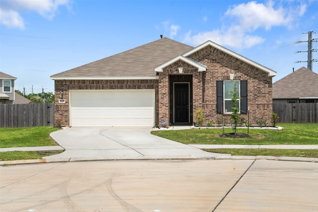 view of front of property featuring a garage and a front yard