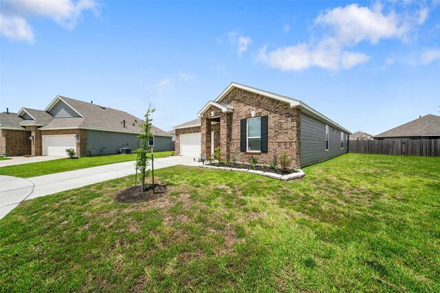 view of front of property with a garage, a front lawn, and central AC