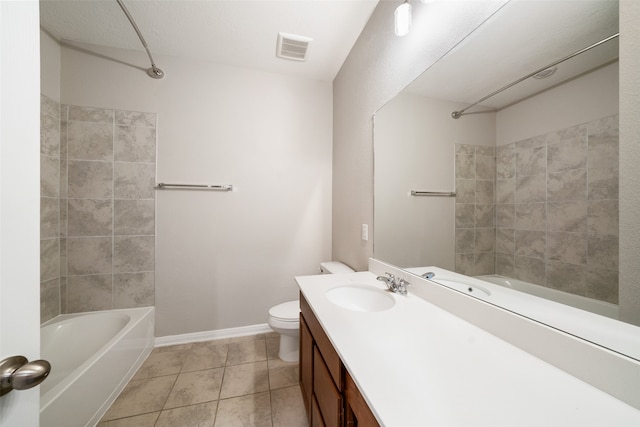 full bathroom featuring a textured ceiling, vanity, toilet, tiled shower / bath, and tile patterned floors