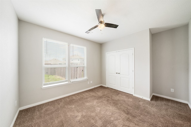 unfurnished bedroom featuring carpet flooring and ceiling fan