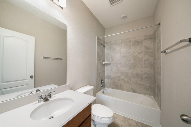 full bathroom featuring tiled shower / bath, vanity, toilet, and tile patterned flooring