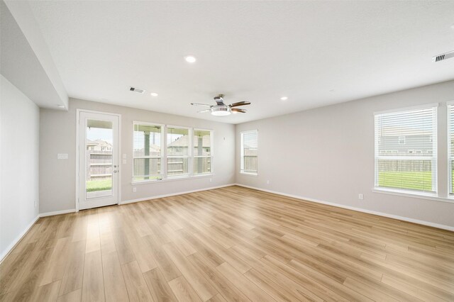 empty room with light wood-type flooring and ceiling fan