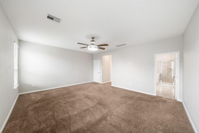 spare room with ceiling fan and carpet floors