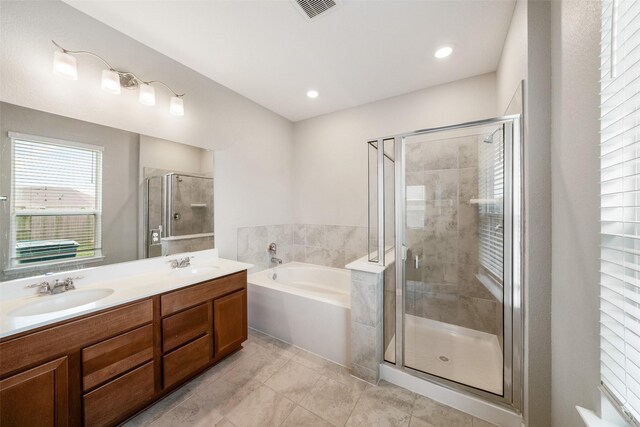 bathroom featuring vanity and plus walk in shower