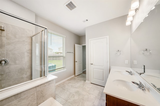 bathroom with plenty of natural light, vanity, tile patterned floors, and an enclosed shower