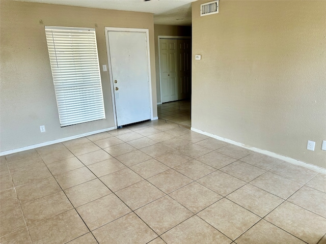 empty room with light tile patterned floors