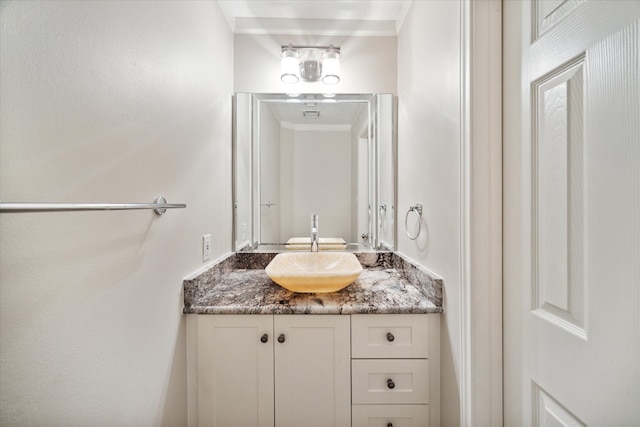 bathroom featuring vanity and ornamental molding