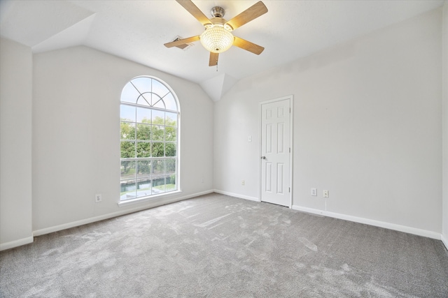 carpeted empty room featuring lofted ceiling and ceiling fan