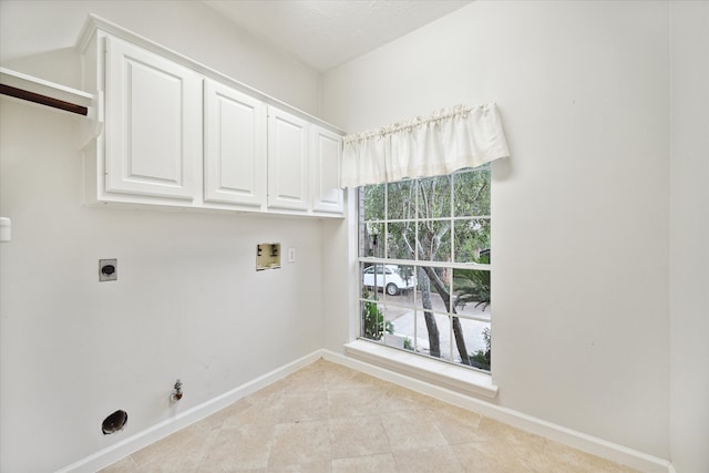 laundry room featuring hookup for a washing machine, hookup for a gas dryer, electric dryer hookup, cabinets, and light tile patterned floors