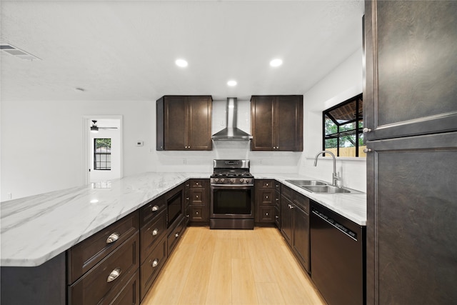 kitchen featuring kitchen peninsula, wall chimney exhaust hood, gas stove, sink, and black dishwasher