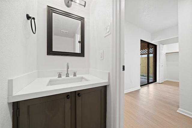 bathroom with vanity and hardwood / wood-style flooring