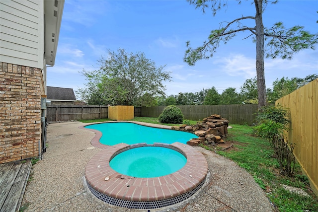 view of swimming pool with an in ground hot tub