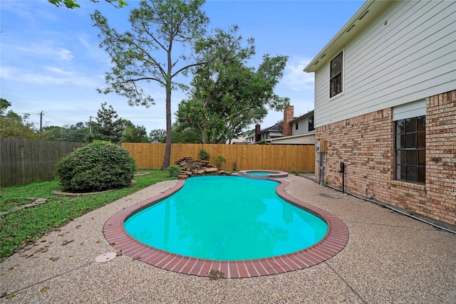 view of swimming pool with an in ground hot tub