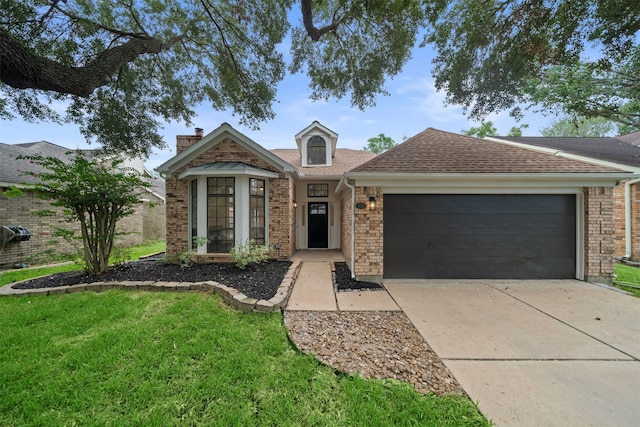 view of front of house with a front lawn and a garage