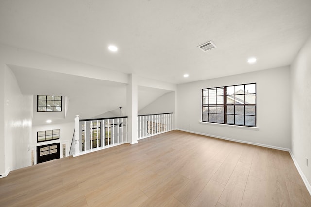 empty room featuring light hardwood / wood-style flooring and vaulted ceiling