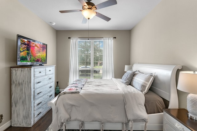 bedroom with dark hardwood / wood-style flooring and ceiling fan