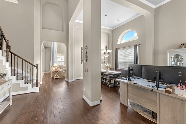 office area with ornamental molding, a high ceiling, a chandelier, and dark hardwood / wood-style floors