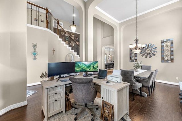 home office featuring an inviting chandelier, a high ceiling, and dark wood-type flooring