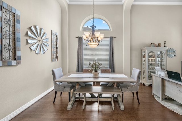 dining space featuring ornamental molding, a chandelier, and dark wood-type flooring