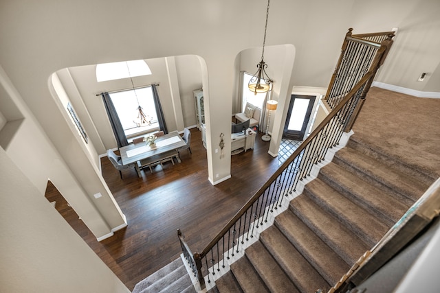 entryway with a notable chandelier, a high ceiling, and dark hardwood / wood-style flooring