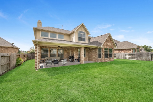 back of property with a yard and a patio area