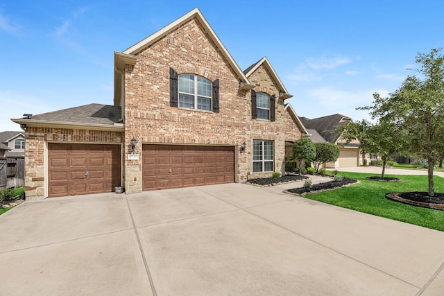 front facade featuring a front yard and a garage