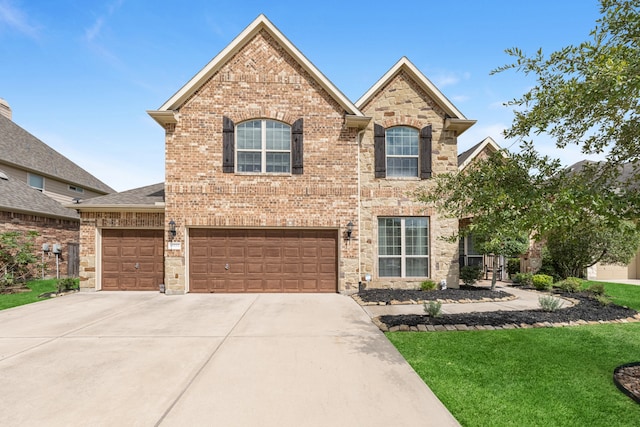 view of property featuring a front yard and a garage