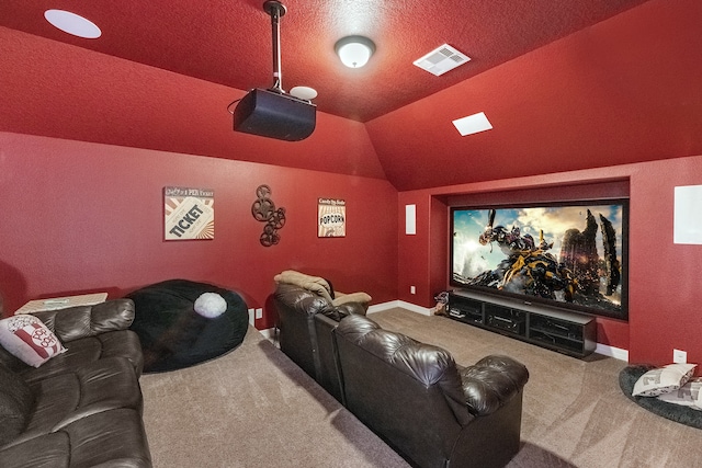 carpeted cinema with a textured ceiling and vaulted ceiling